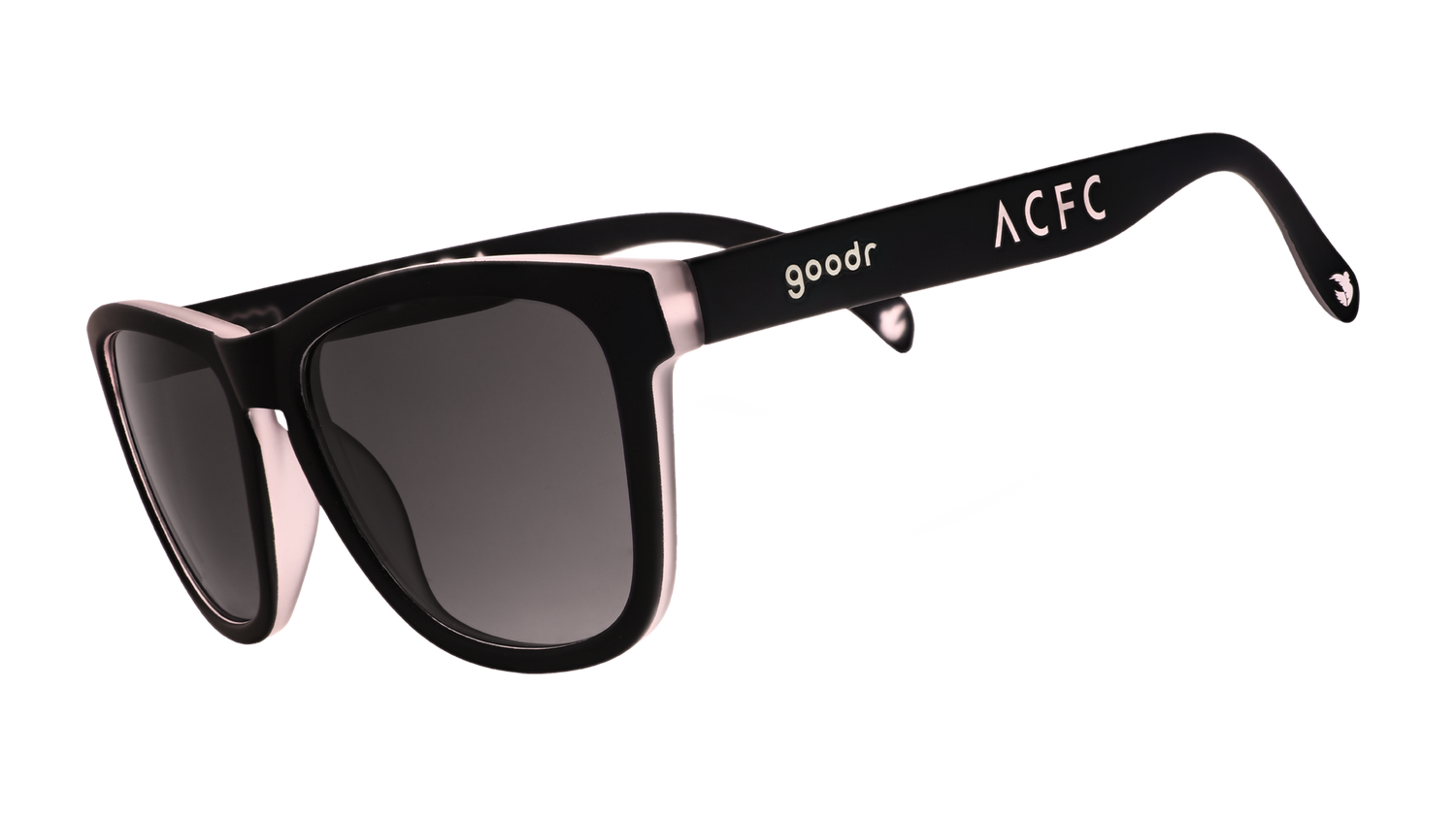 Three-quarter angle view of black and pink sunglasses with black gradient lenses and ACFC logo.