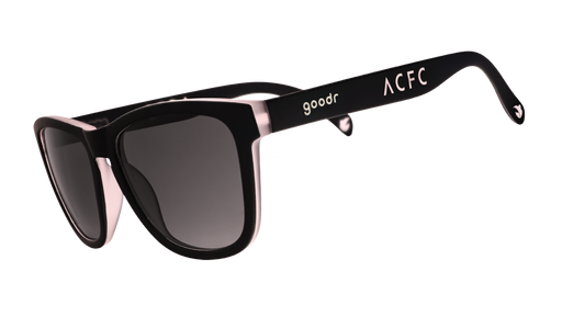 Three-quarter angle view of black and pink sunglasses with black gradient lenses and ACFC logo.