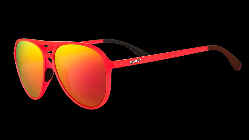 Three-quarter angle view of red aviator sunglasses with bright red mirrored lenses and black silicone inner nose & ear grips.