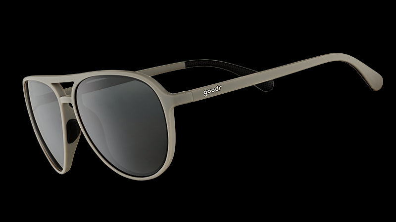 Three-quarter angle view of matte gray aviator sunglasses with non-reflective black lenses on a white background.