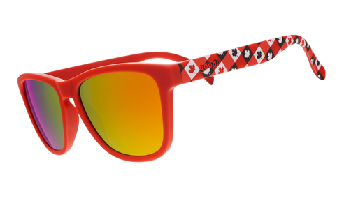 Three-quarter angle view of red Canada sunglasses with maple leaf-patterned frames and burnt orange reflective lenses.