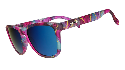 Three-quarter angle view of kintsugi sunglasses with teal lenses, purple-teal frames, and gold crack accents.