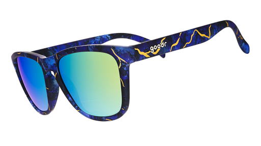 Three-quarter angle view of kintsugi sunglasses with gold lenses, inky blue frames, and gold crack accents.