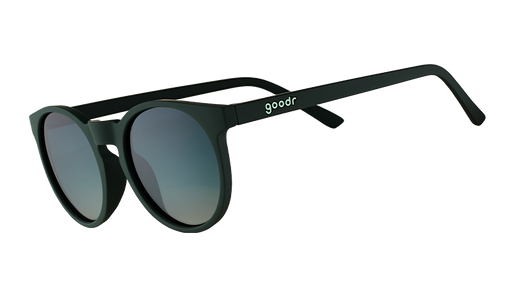 Three-quarter angle view of dark green round sunglasses with circle-shaped green gradient lenses.