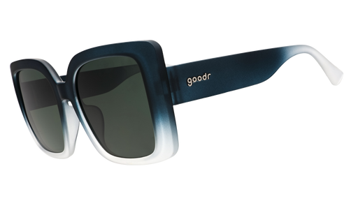 Three-quarter angle view of oversized square green sunglasses with non-reflective gradient lenses.