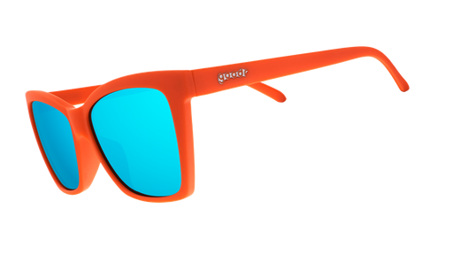Three-quarter angle view of red angular sunglasses with blue reflective lenses.