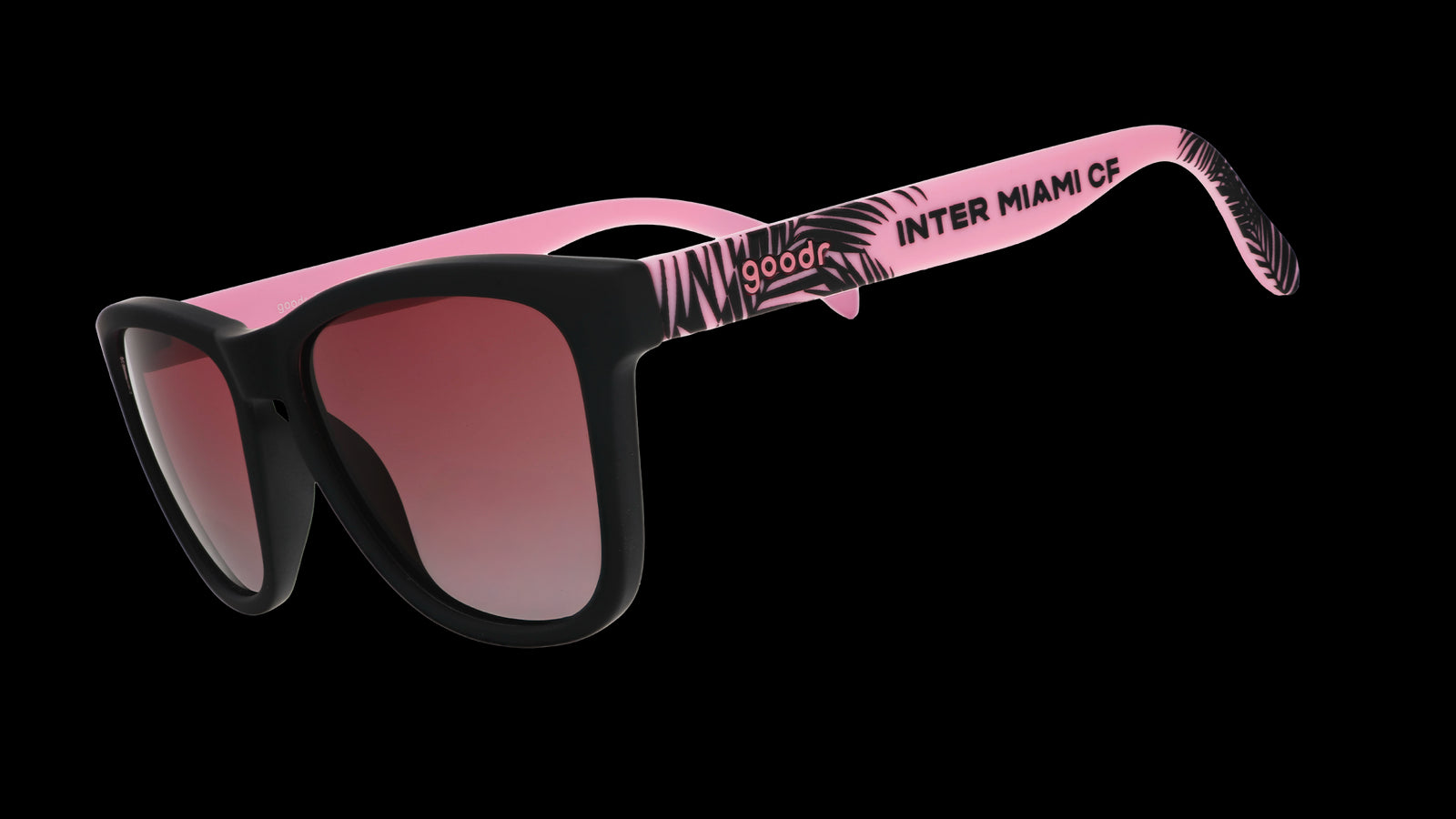 Three-quarter angle view of Inter Miami CF Major League Soccer sunglasses with black and pink frames and rose lenses.