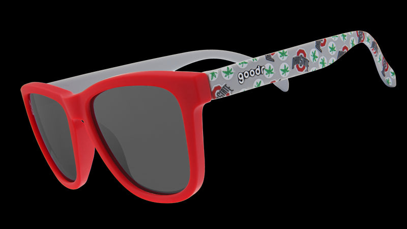 Sunglasses with a bright red frame and dark lenses, paired with white arms adorned with Ohio-themed designs in green and red.