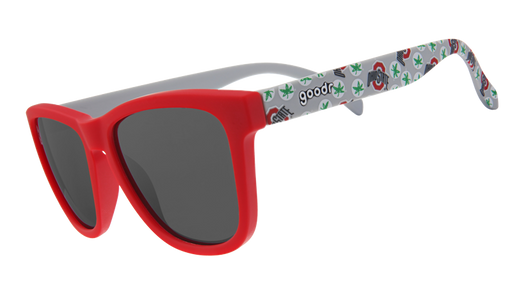 Sunglasses with a bright red frame and dark lenses, paired with white arms adorned with Ohio-themed designs in green and red.