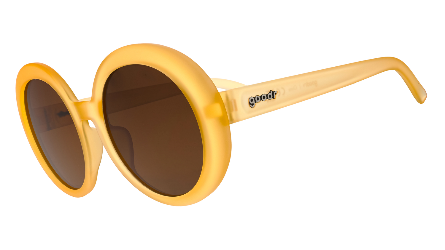 Three-quarter view of a pair of oversized, round, pale orange sunglasses with brown, non-reflective lenses.