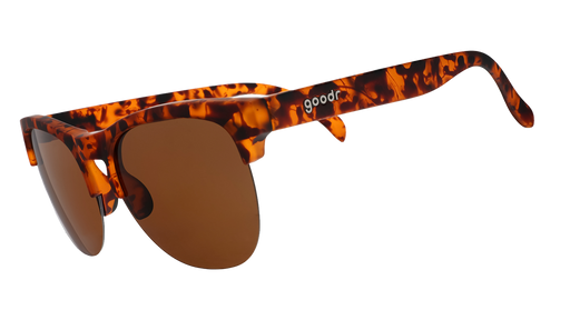 Three-quarter angle view of brown tortoiseshell half-rim sunglasses with brown non-reflective lenses.