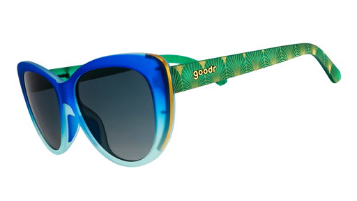 Three-quarter angle view of blue and green ombré cat-eye frames with green gradient lenses and a peacock-inspired design.