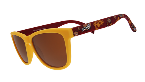 A pair of "goodr" sunglasses with yellow frames and brown-tinted lenses. The arms of the sunglasses feature a maroon background with gold University of Minnesota "M" logos and mascots, creating a collegiate-themed design.