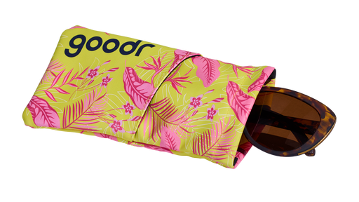 Three-quarter angle view of a soft fabric sunglasses case featuring a tropical design. A pair of tortoiseshell shades is shown partially pulled out.