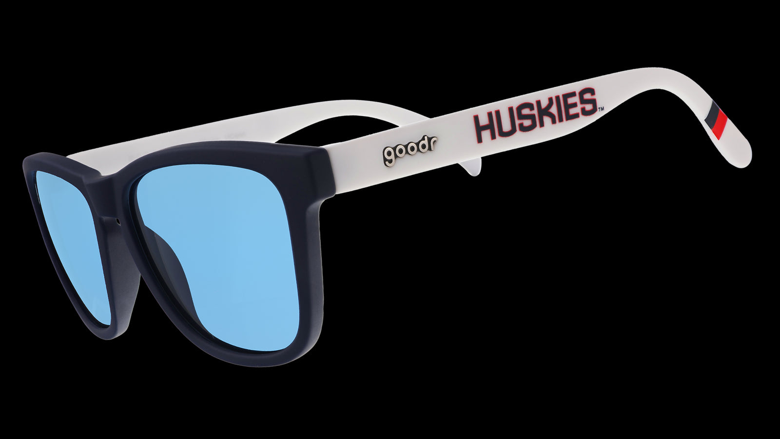 Three-quarter angle view of navy blue and white sunglasses with the Huskies logo and blue lenses.