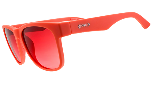 A pair of bright red sunglasses featuring reflective red lenses and the "goodr" logo on the arm. The frame has a sleek, bold design with a glossy finish.