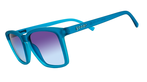 A pair of square goodr sunglasses with blue frames and transparent purple lenses, on a white background.