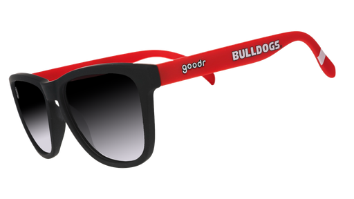 A pair of sunglasses with black frames and lenses, and red temples that have the word "Bulldogs" written in white along the side.