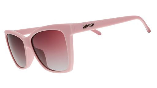 A pair of cat-eye sunglasses with light pink frames and rosy lenses.