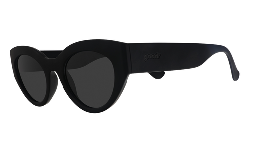 Three-quarter angle view of translucent black, retro-inspired angled cat-eye sunglasses with non-reflective lenses.