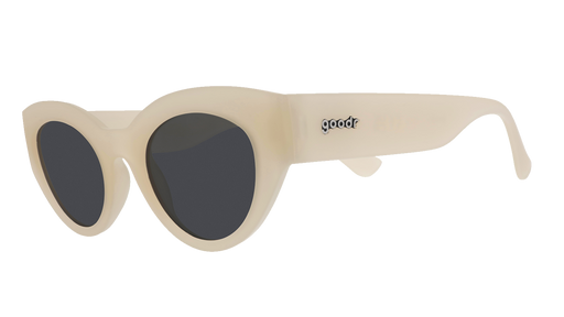 Three-quarter angle view of translucent soft cream, retro-inspired angled cat-eye sunglasses with black non-reflective lenses.