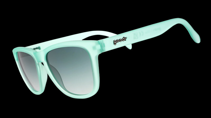 Light mint green sunglasses with a glossy finish, featuring gradient lenses and the "goodr" logo on the temple.