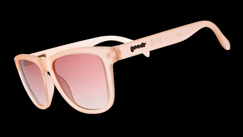 Sunglasses with translucent pink frames and gradient pink lenses.