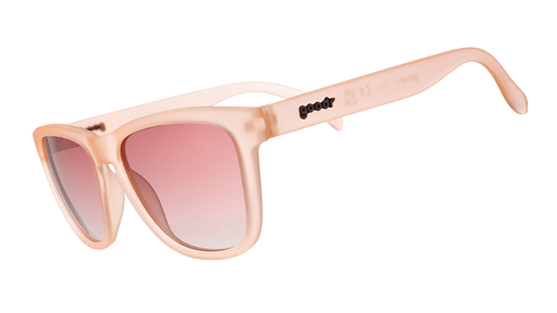 Sunglasses with translucent pink frames and gradient pink lenses.