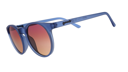Three-quarter angle view of dark blue circular sunglasses with purple-yellow ocean lenses.