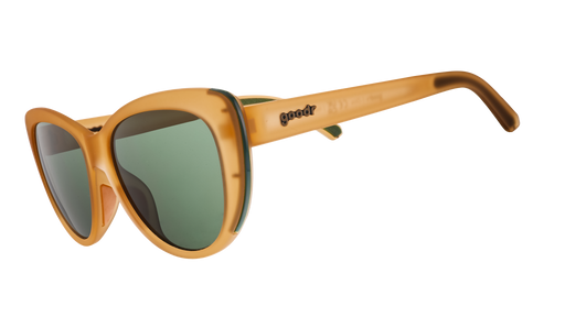 Three-quarter angle view of translucent brown cat-eye sunglasses with green non-reflective lenses.