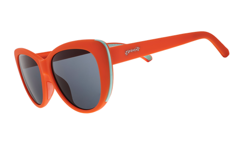 Three-quarter angle view of red cat-eye sunglasses with black non-reflective lenses.