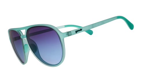 Three-quarter angle view of translucent teal aviator sunglasses with dark blue gradient lenses.