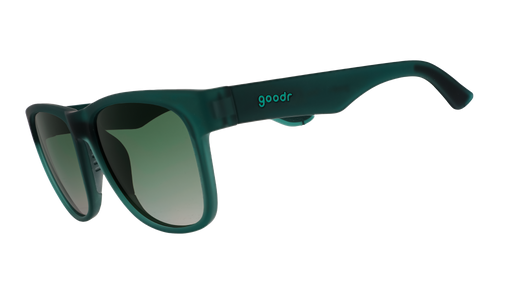 Three-quarter angle view of large dark teal sunglasses with green gradient lenses.