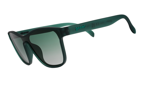 Three-quarter angle view of translucent teal one-lens sunglasses with green gradient lenses.