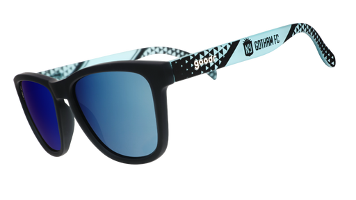 Sunglasses with blue lenses and patterned black and white frame on a white background