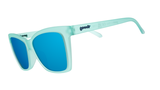 Three-quarter angle view of translucent teal angular sunglasses with reflective teal lenses.