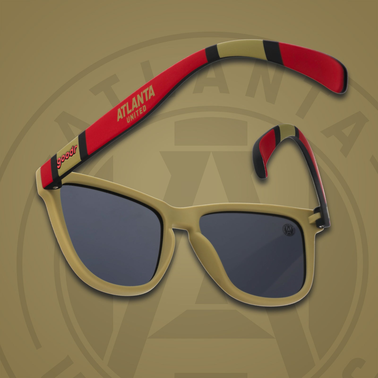 Three-quarter angle back view of MLS Atlanta United shades on a gold background. Gold+red frames. Black lenses.