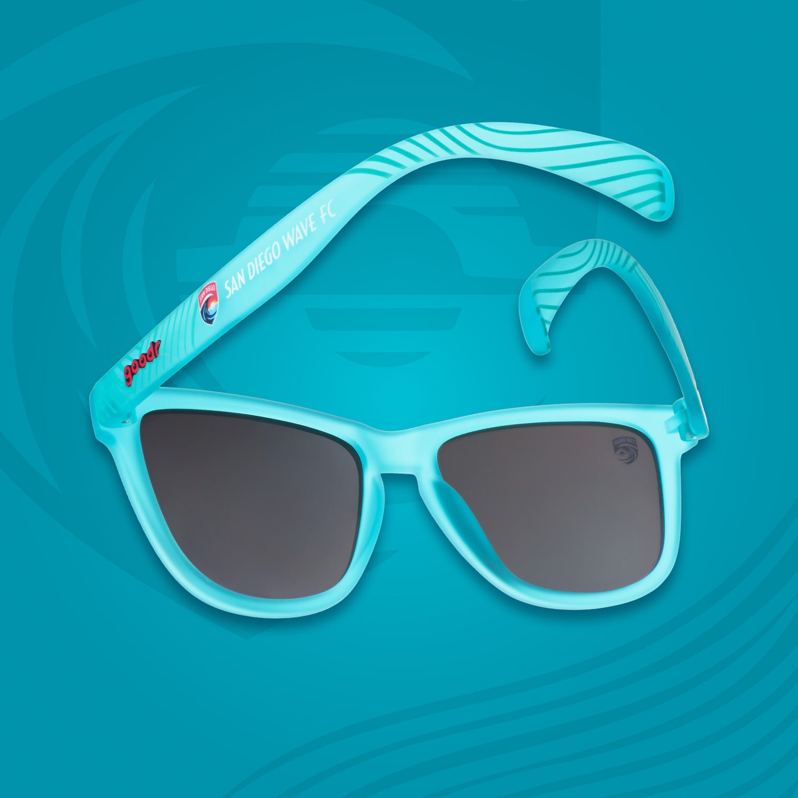 Blue sunglasses with dark lenses on a blue background