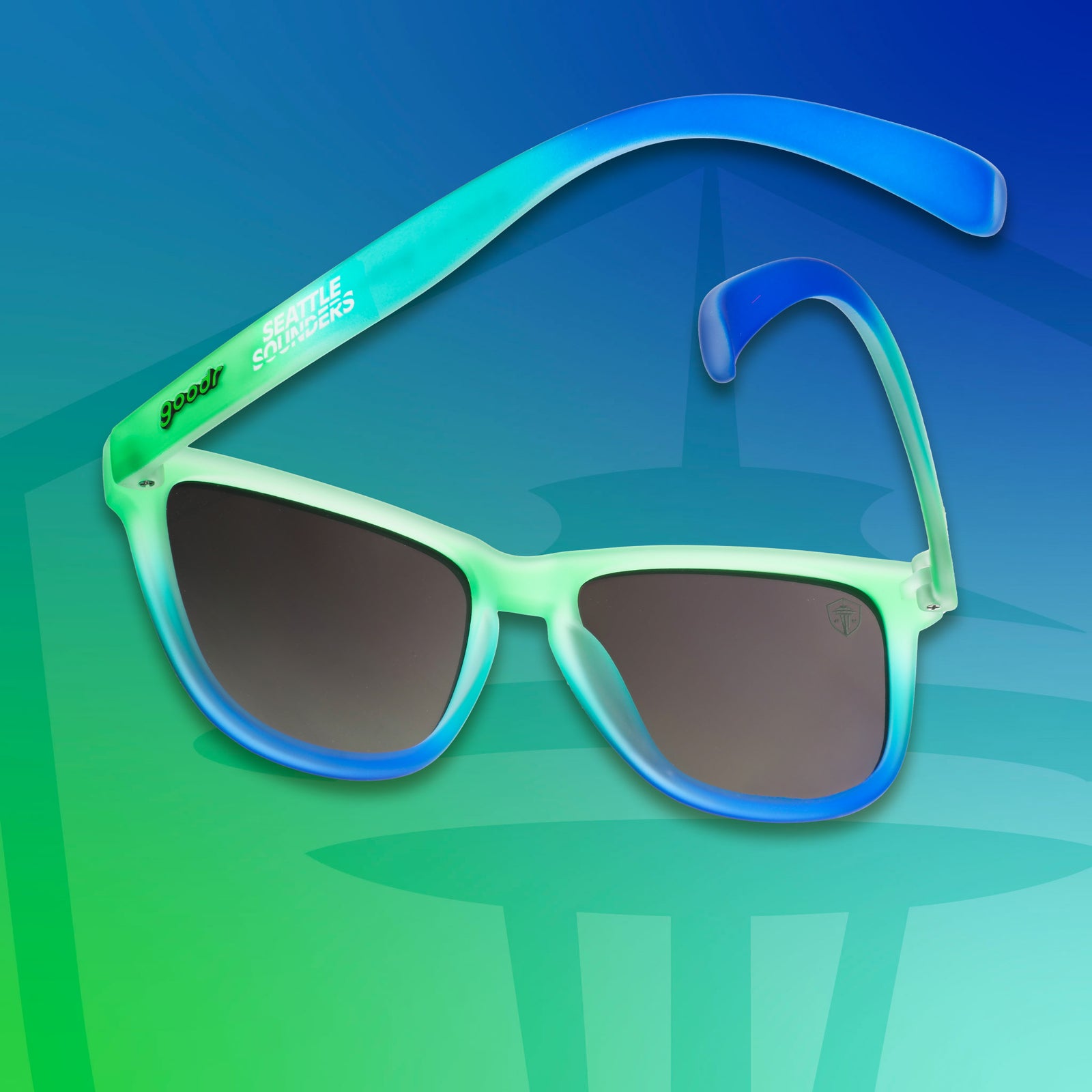 Three-quarter angle view of Seattle Sounders shades tilted down. Green-blue frames. Green lenses. Green-blue background.