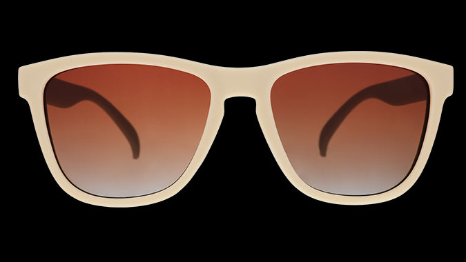 A pair of square sunglasses with light beige frames and orange lenses.