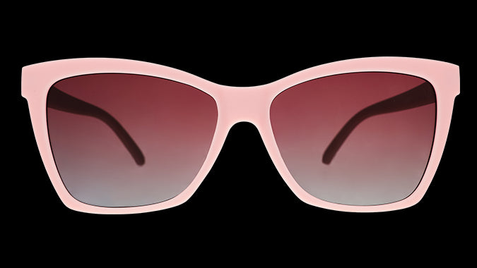 A pair of cat-eye sunglasses with light pink frames and rosy lenses.