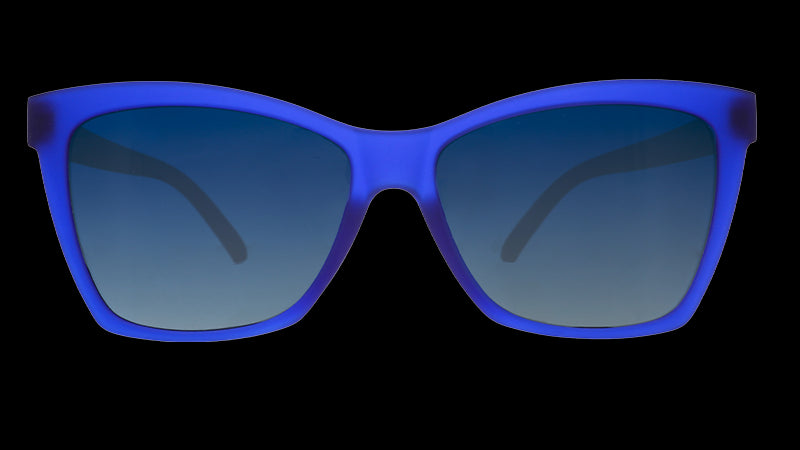 Front view of translucent dark blue angled cat-eye sunglasses with blue gradient lenses.