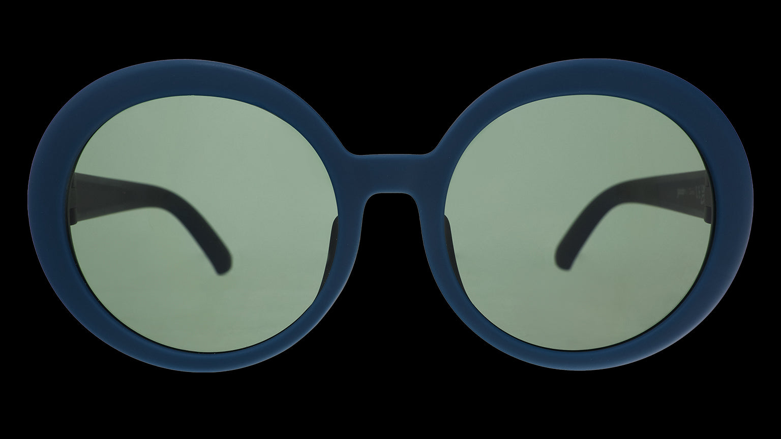 Front angle view of a pair of oversized round sunglasses frames in a shade of deep green with green non-reflective lenses.
