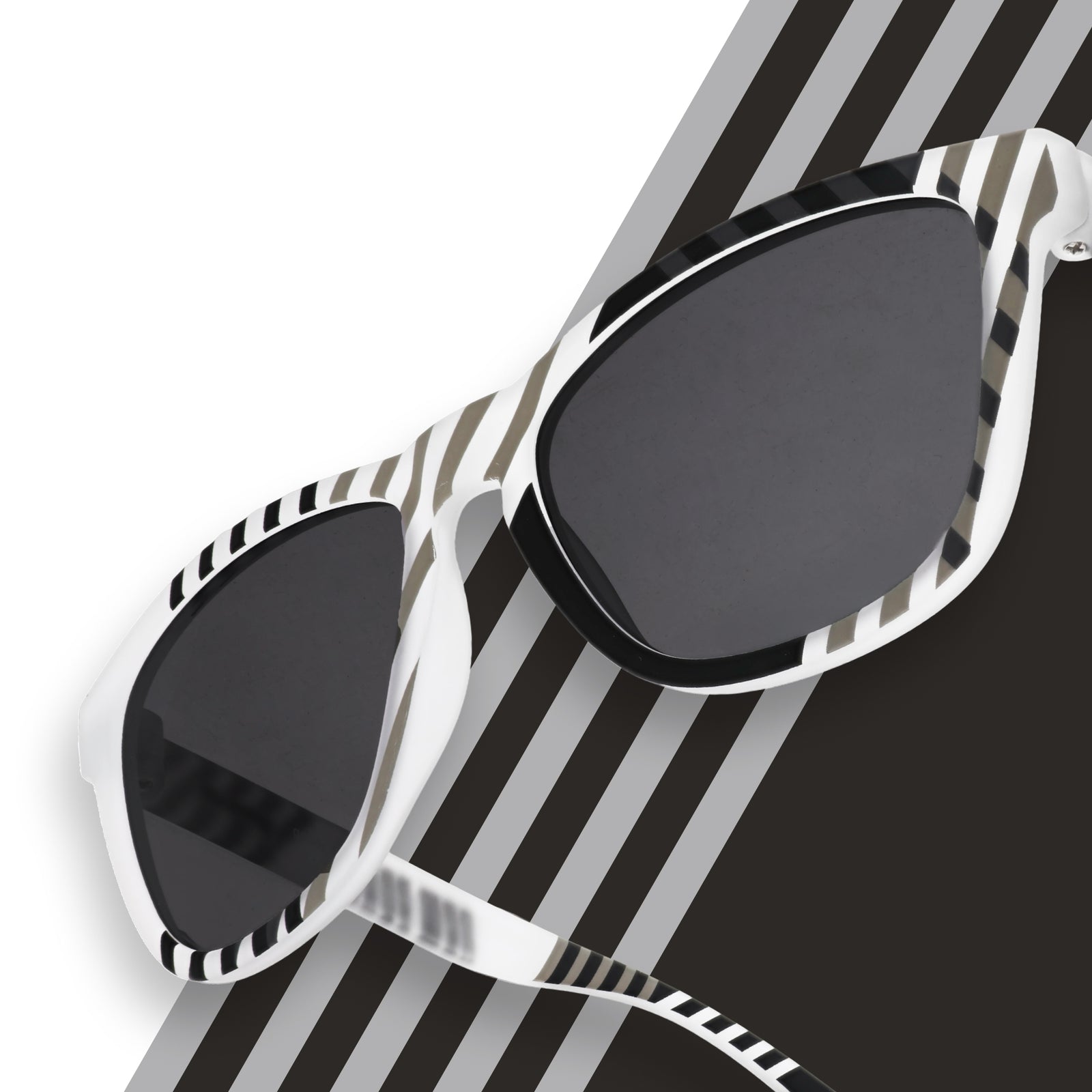 Three-quarter angle close-up of gray and black sunglasses featuring a geometric print and black non-reflective lenses.