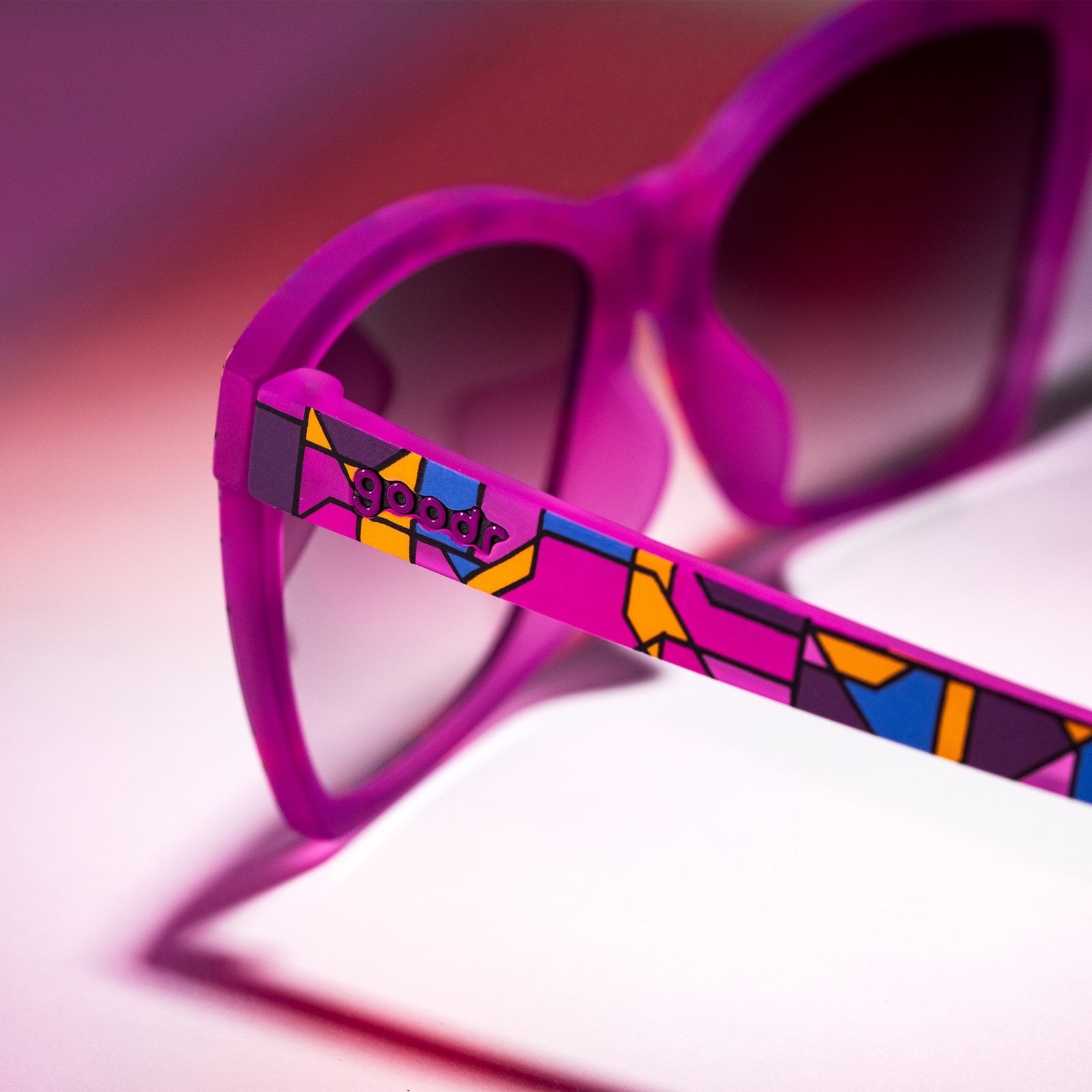 A pair of purple Pop Gs with a stained glass-inspired design is photographed from behind, showcasing the design on the arm.