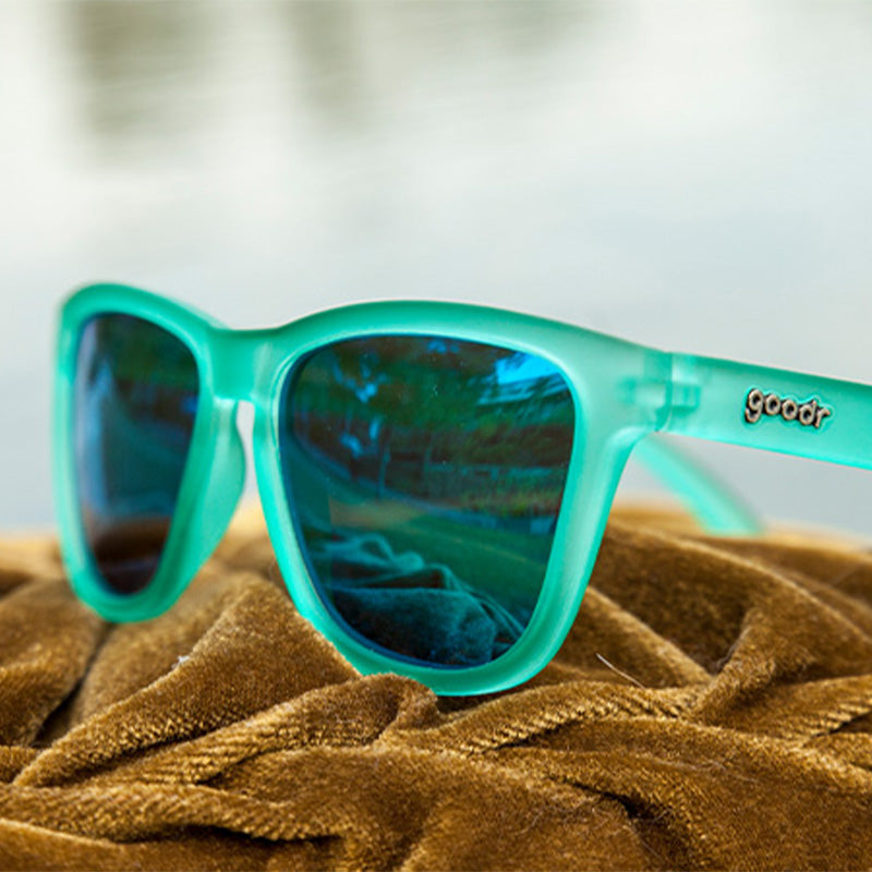 A pair of square shaped, mint green sunglasses.