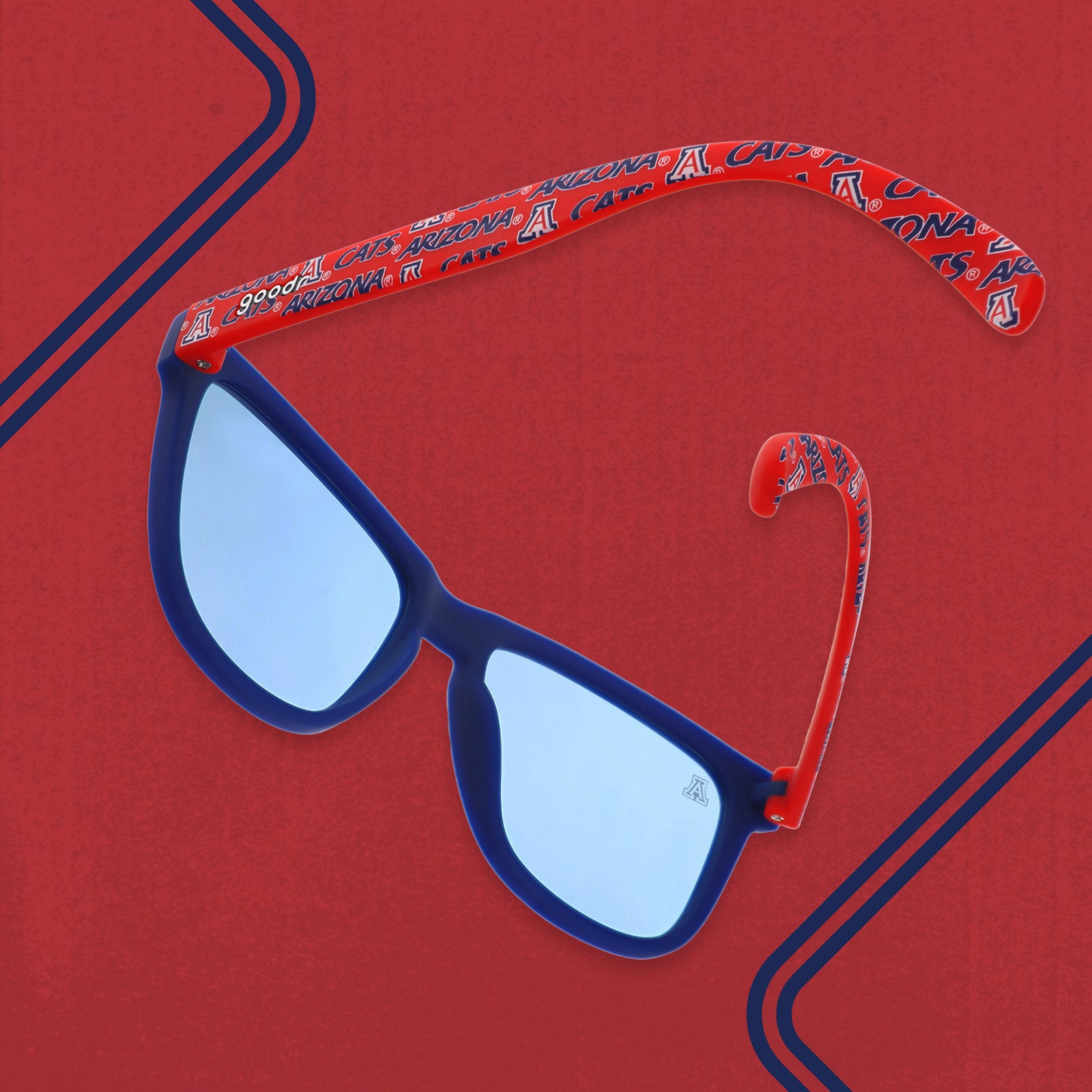 Three-quarter back angle view of red and dark blue sunglasses with an Arizona print and blue lenses.