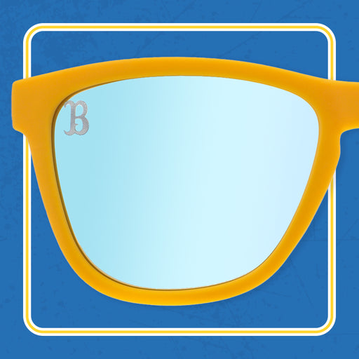 One lens of a pair of yellow sunglasses, with a B in the top left corner
