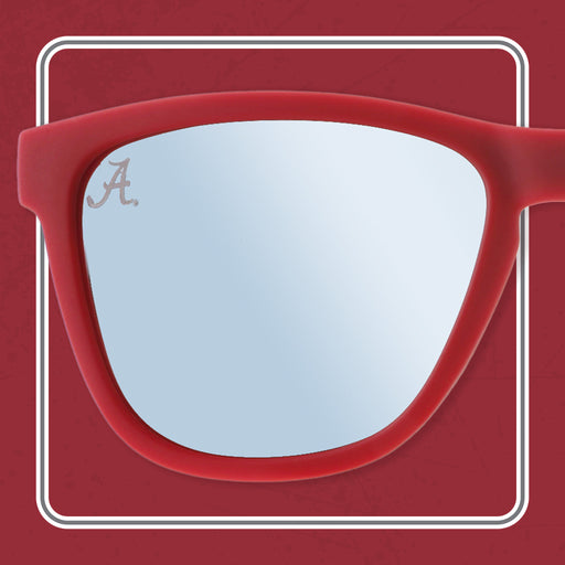 A close-up of red sunglasses with reflective lenses. The left lens features a subtle "A" logo in the top corner, and the background is a matching red with a white border.