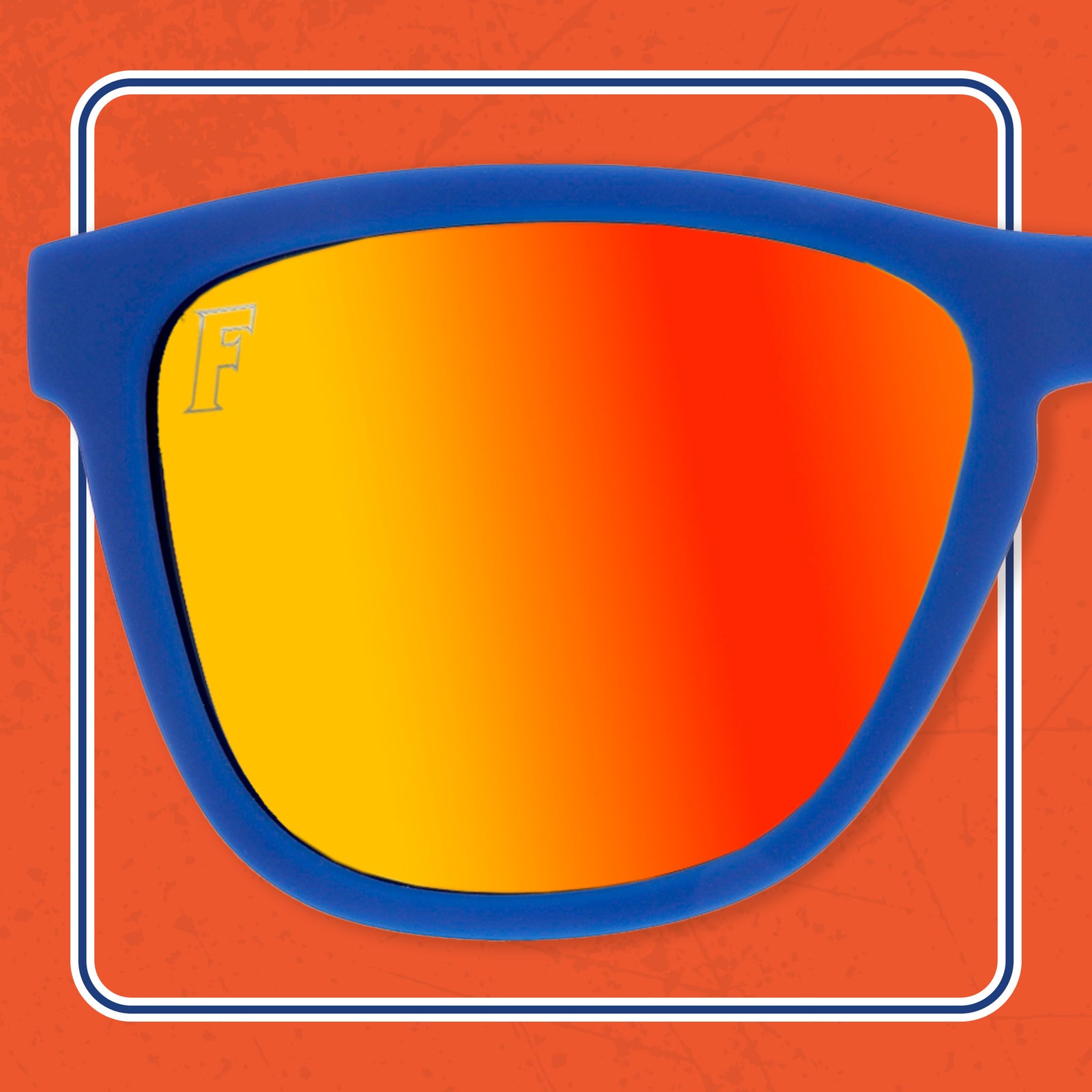 One orange ombre lens of a pair sunglasses, with royal blue temples
